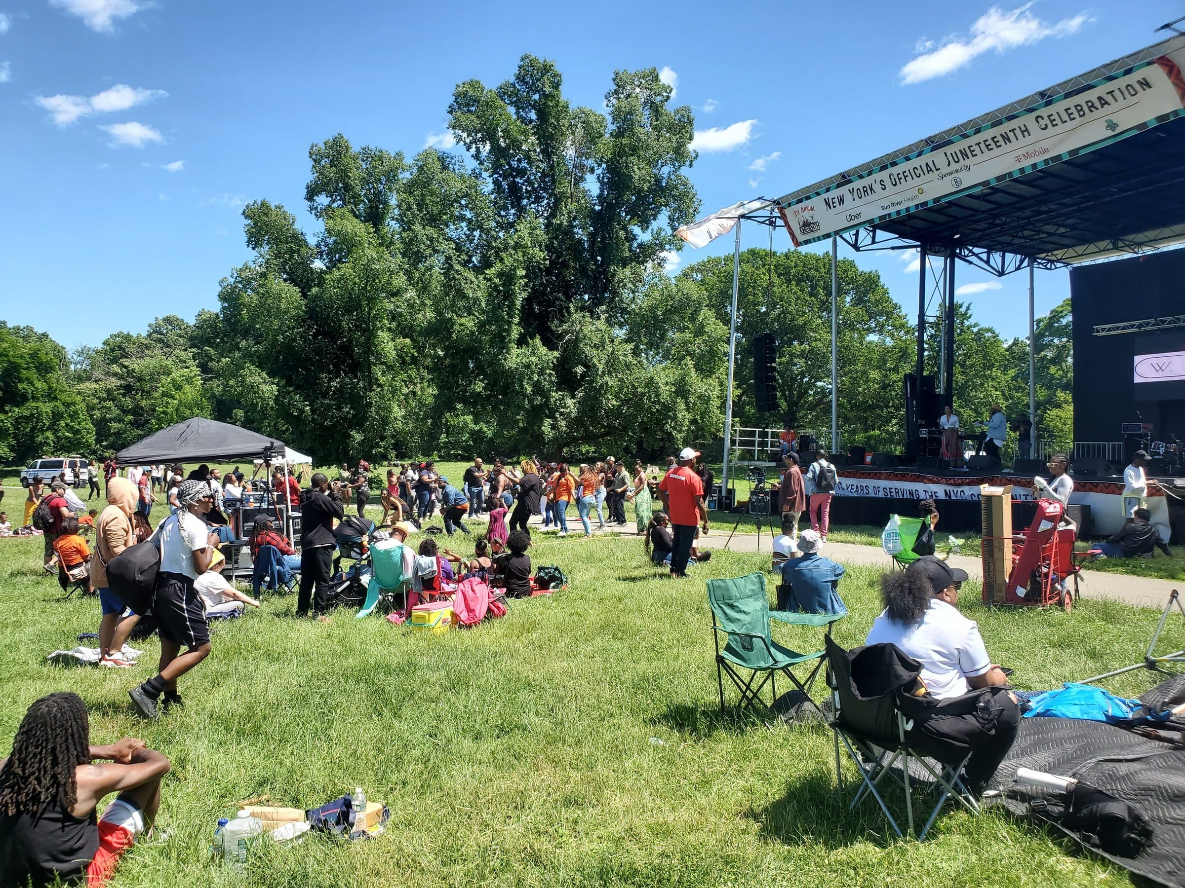 Guests gathered on the lawn for an outdoor stage program