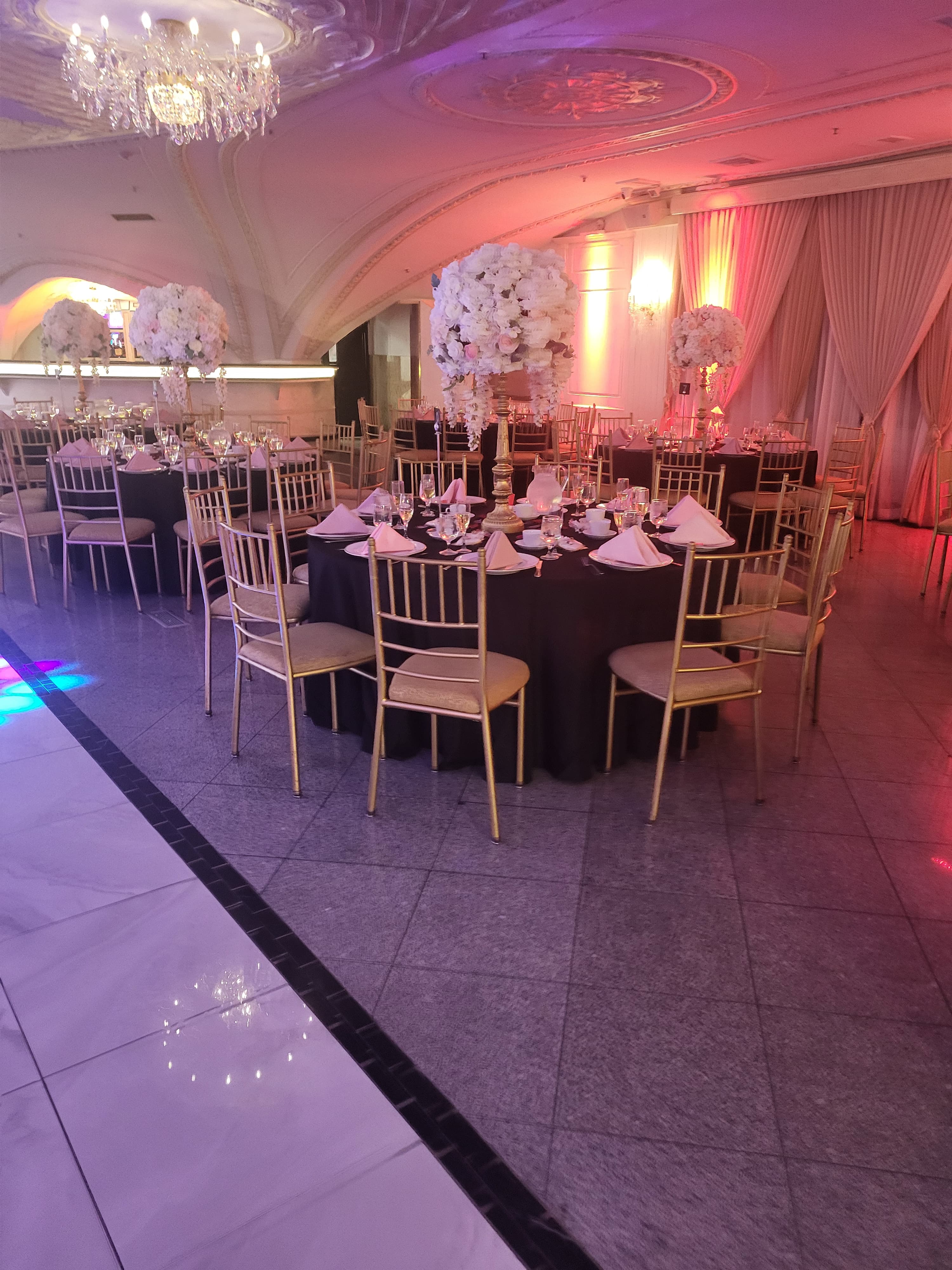 Ballroom gala tables with tall florals produced by Flow C Inc.
